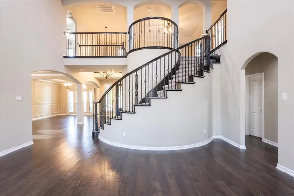 a view of staircase with wooden floor and a window