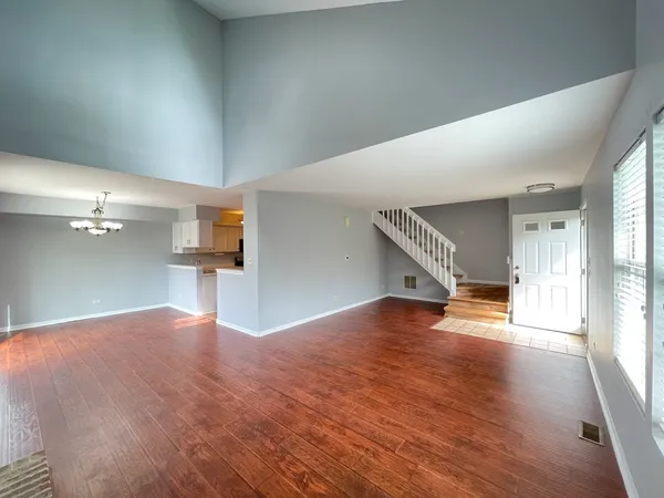 a view of an empty room and wooden floor