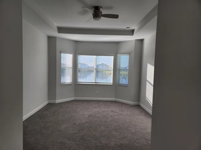 an empty room with a empty space and windows