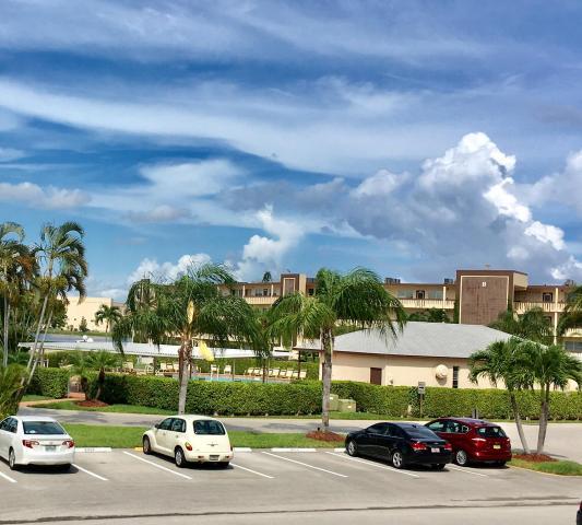 2022 Wolverton East, Unit 2022 Boca Raton, FL 33434 - Photo 12 of 21 a view of a cars park in front of a building