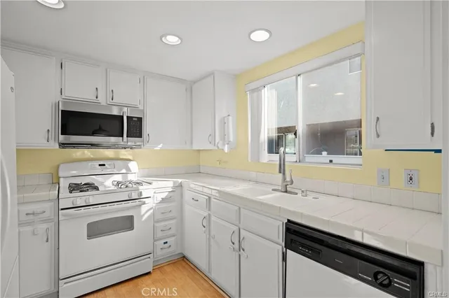 a kitchen with a sink stove and microwave