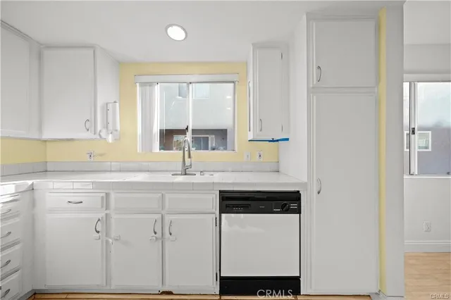 a kitchen with stainless steel appliances granite countertop white cabinets and a granite counter tops