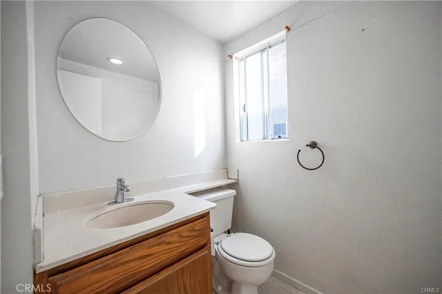 a bathroom with a sink toilet and a mirror