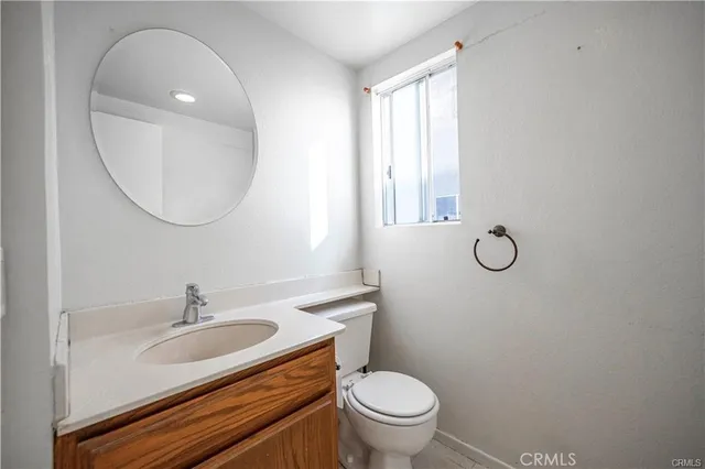 a bathroom with a sink toilet and a mirror