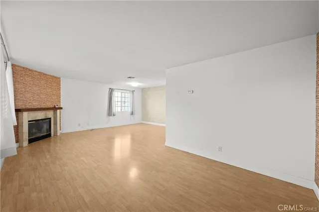 a view of empty room with a fireplace