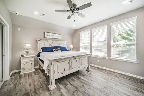 a bedroom with a large bed and a window