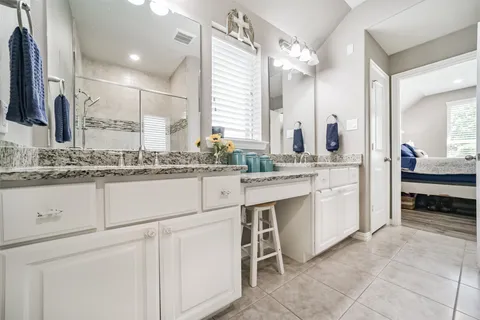 a bathroom with a sink vanity and mirror