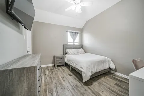 a bedroom with a bed and a mirror