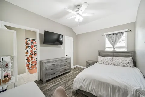 a bedroom with a bed and a flat screen tv