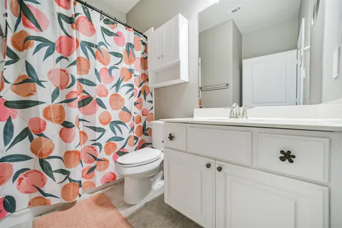 a bathroom with a sink and mirror with toilet
