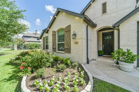 a view of a house with potted plants