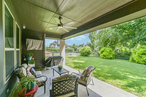 a view of an outdoor dining space with a table chairs and a backyard