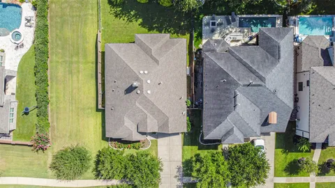 an aerial view of a house with a yard and plants