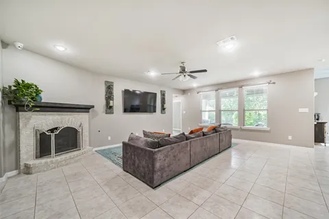 a living room with furniture a flat screen tv and a fireplace