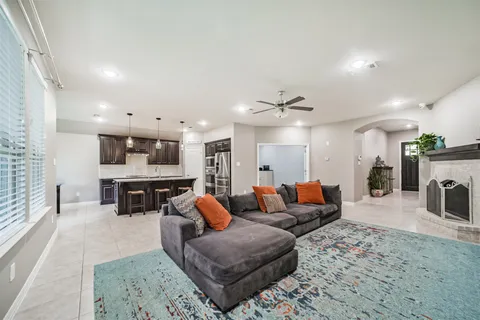 a living room with furniture and kitchen view