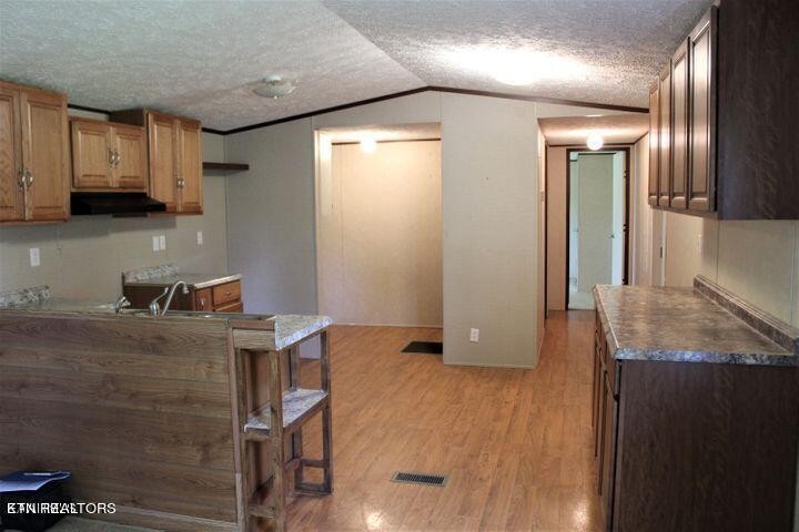 340 Brakebill Road Vonore, TN 37885 - Photo 11 of 33 a kitchen with granite countertop a sink a stove and cabinets