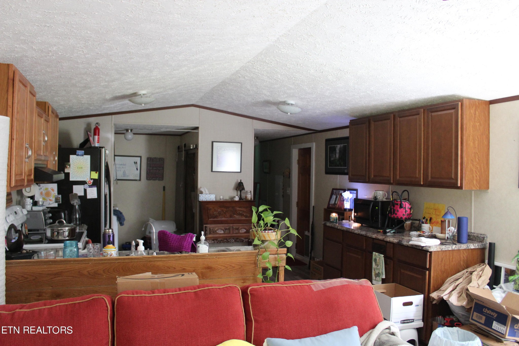 340 Brakebill Road Vonore, TN 37885 - Photo 13 of 33 a kitchen with a refrigerator and a couch