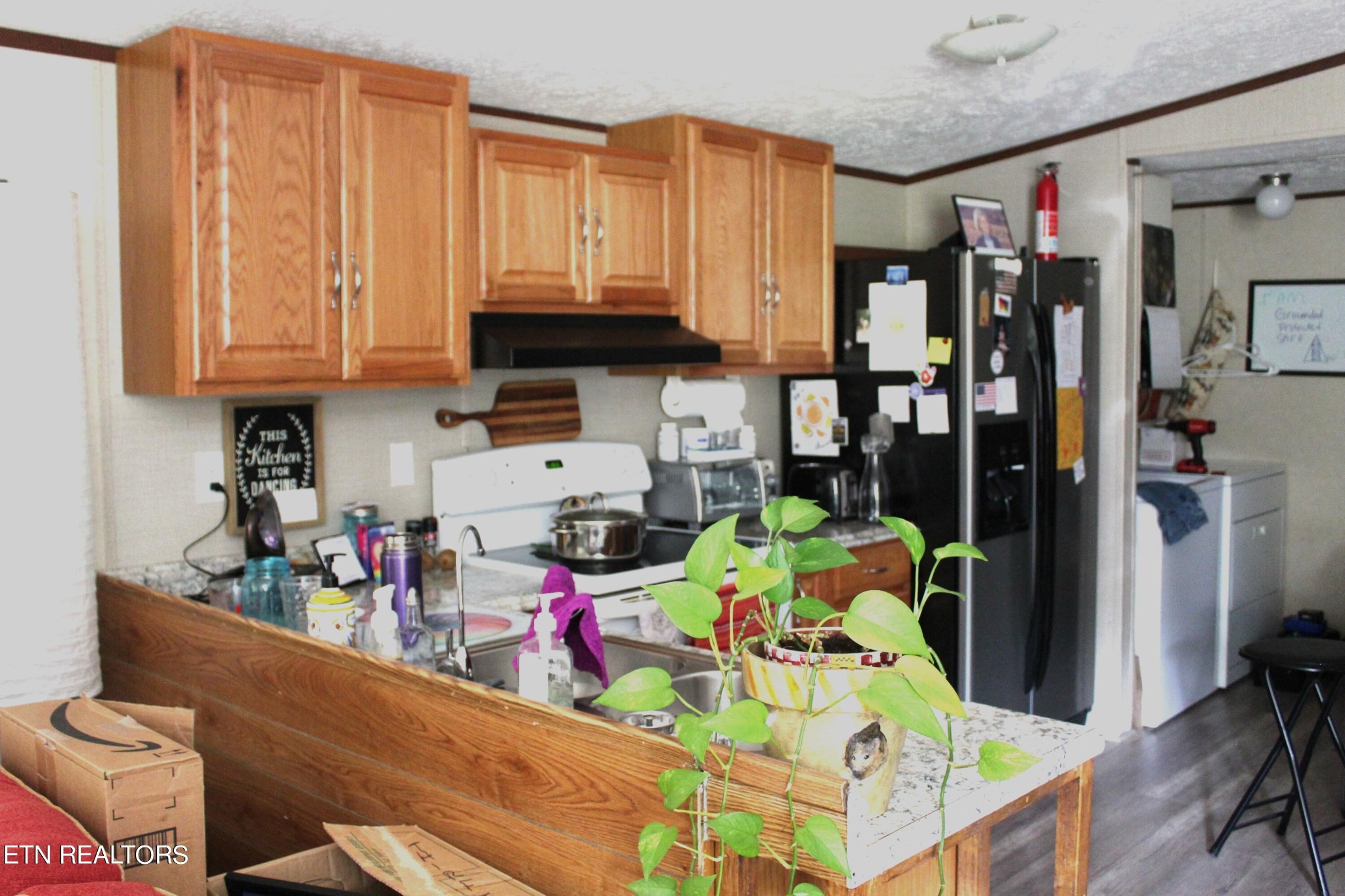 340 Brakebill Road Vonore, TN 37885 - Photo 14 of 33 a kitchen with stainless steel appliances wooden floor and table chairs
