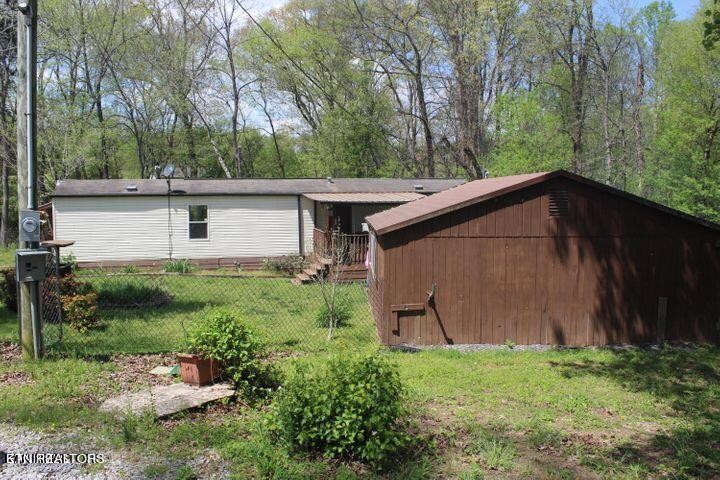 340 Brakebill Road Vonore, TN 37885 - Photo 3 of 33 a backyard of a house with lots of green space