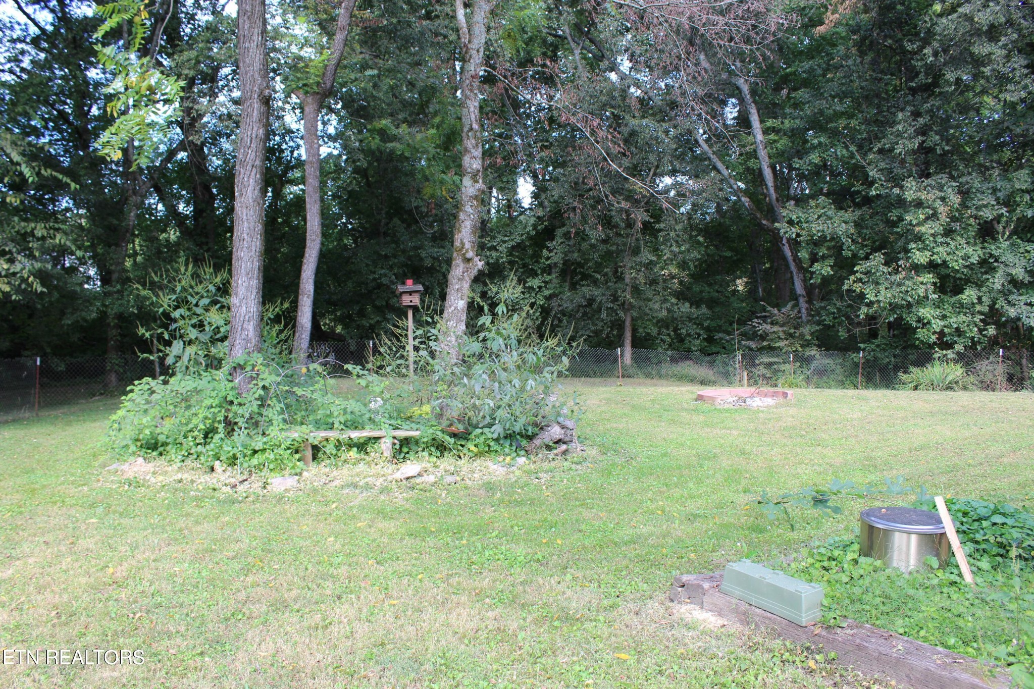 340 Brakebill Road Vonore, TN 37885 - Photo 31 of 33 a backyard of a house with lots of green space and fountain