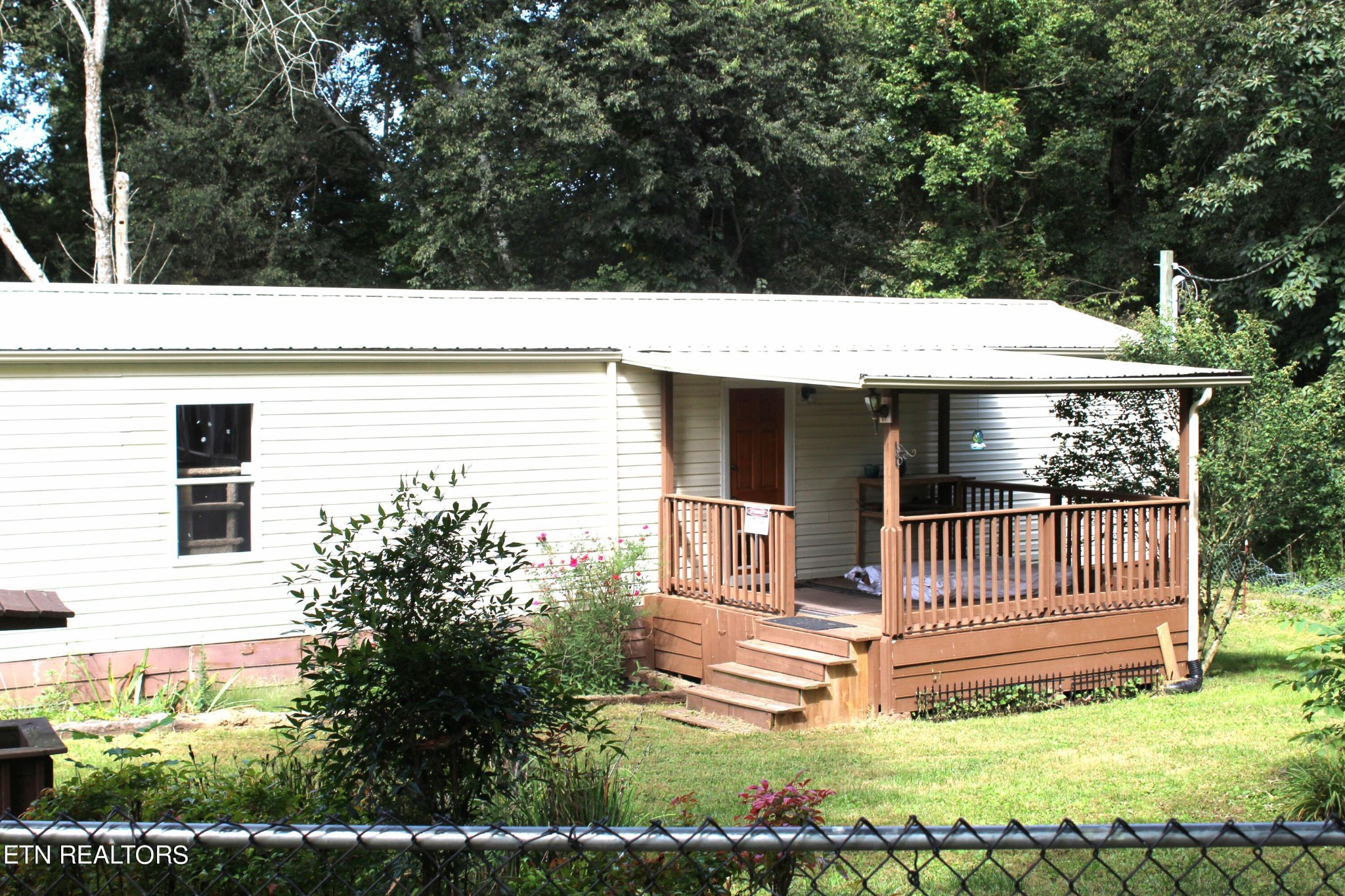 340 Brakebill Road Vonore, TN 37885 - Photo 5 of 33 a view of house with backyard porch and furniture