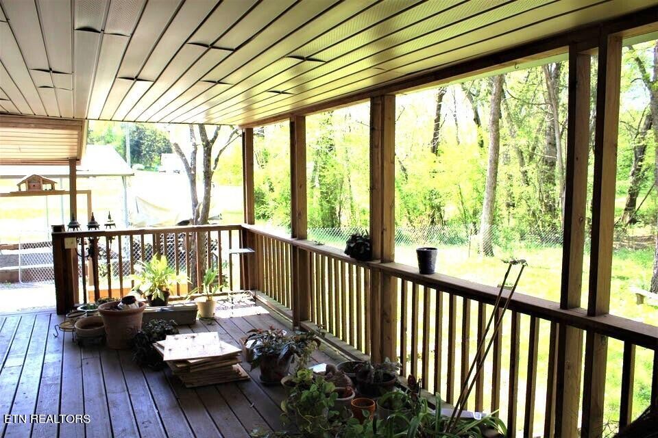 340 Brakebill Road Vonore, TN 37885 - Photo 6 of 33 a living room filled with furniture and floor to ceiling windows
