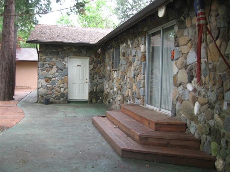 4988 Holland Loop Road Cave Junction, OR 97523 - Photo 7 of 35 a view of backyard with a entryway