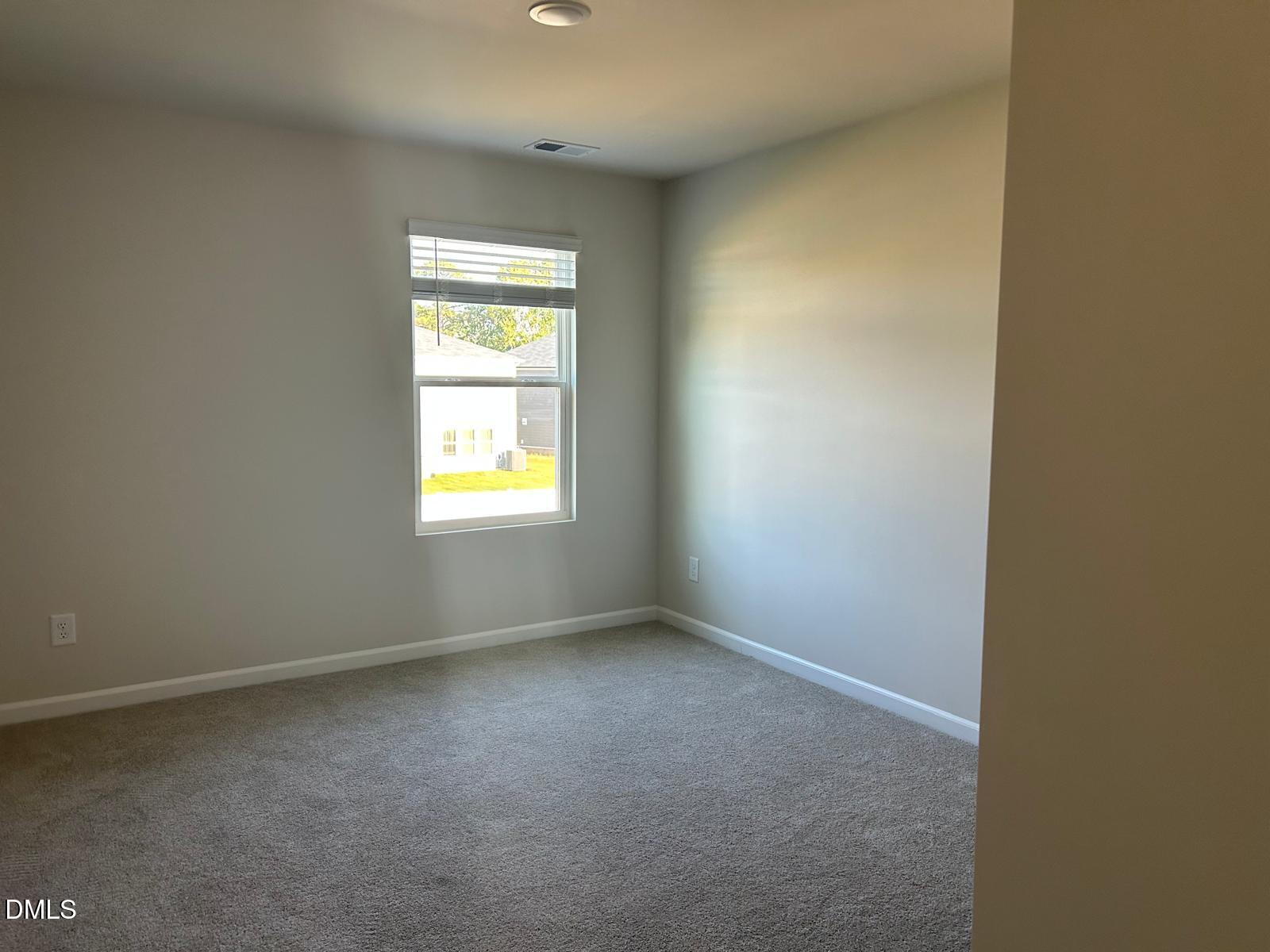 1220 Whitespire Way Zebulon, NC 27597 - Photo 12 of 20 an empty room with window
