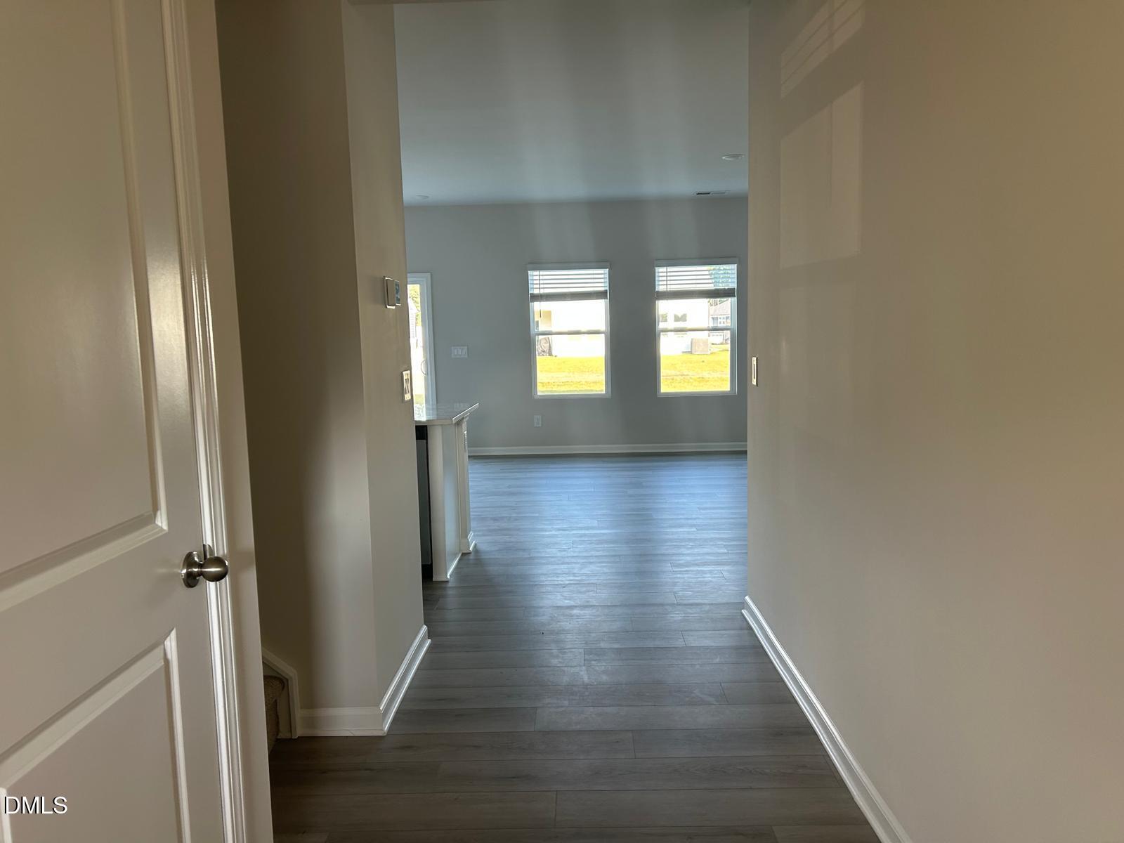 1220 Whitespire Way Zebulon, NC 27597 - Photo 13 of 20 an empty room with wooden floor and windows