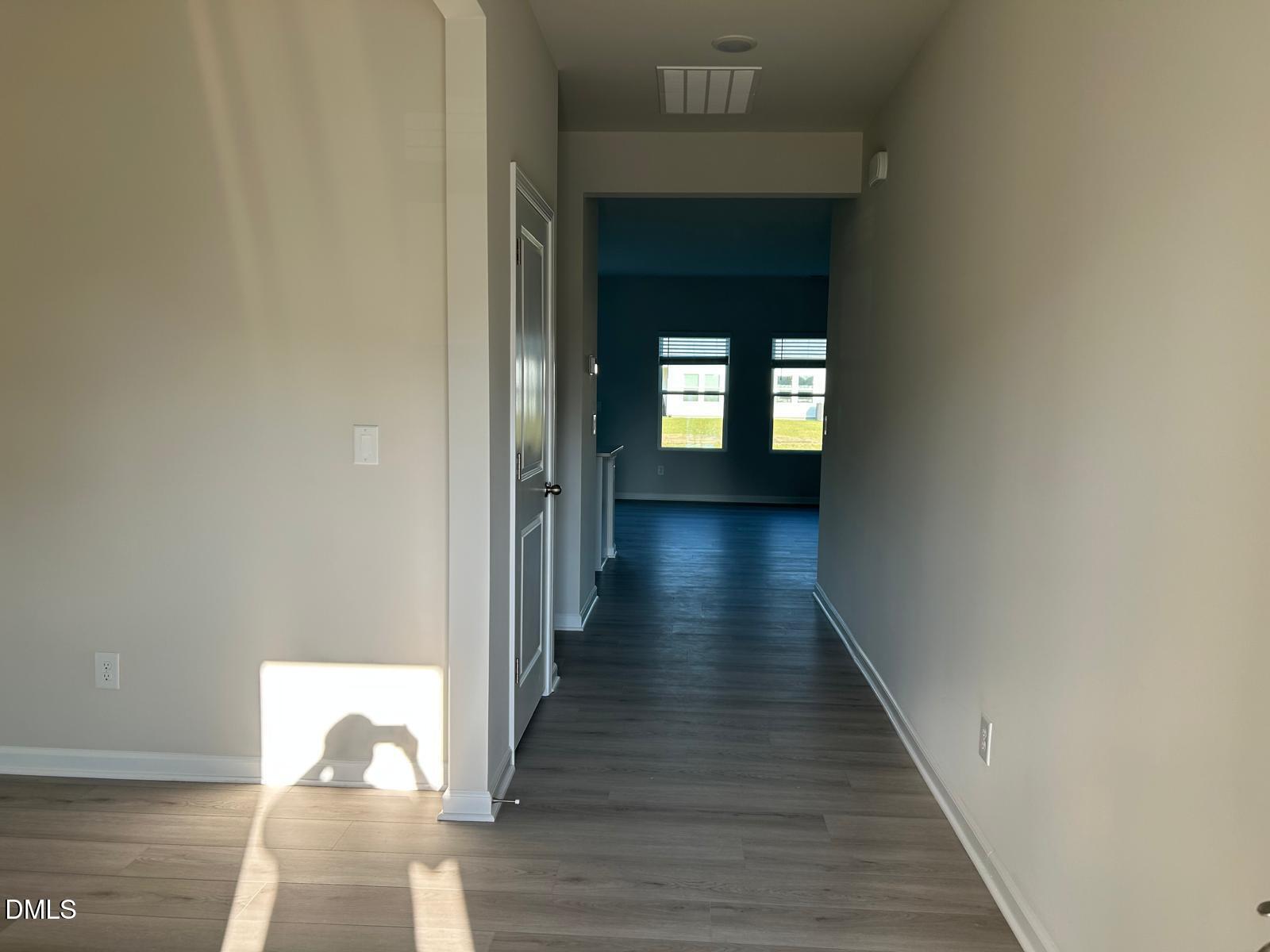 1220 Whitespire Way Zebulon, NC 27597 - Photo 2 of 20 a view of a hallway with wooden floor and staircase