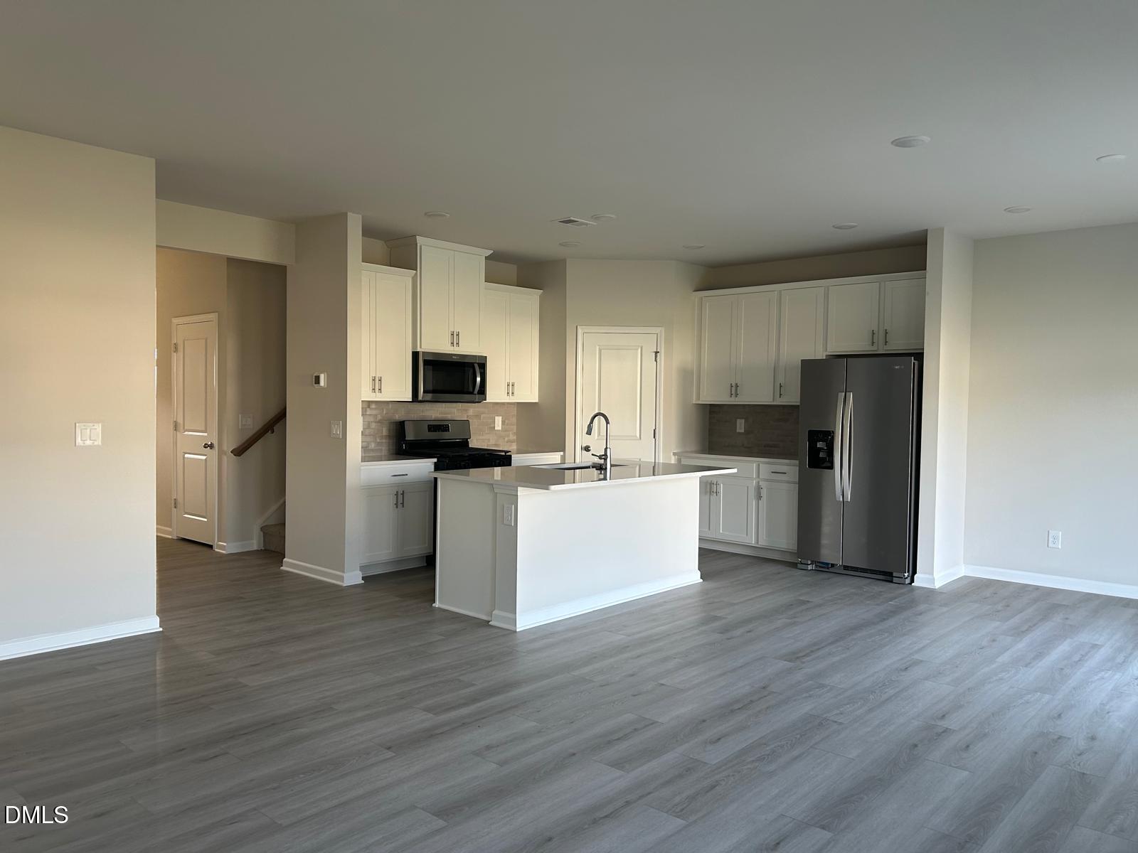 1220 Whitespire Way Zebulon, NC 27597 - Photo 4 of 20 a view of kitchen with stainless steel appliances refrigerator stove microwave and cabinets