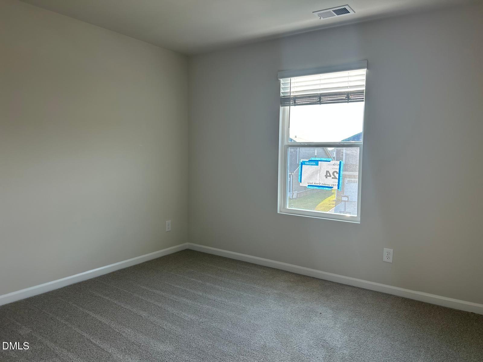 1220 Whitespire Way Zebulon, NC 27597 - Photo 6 of 20 an empty room with a window