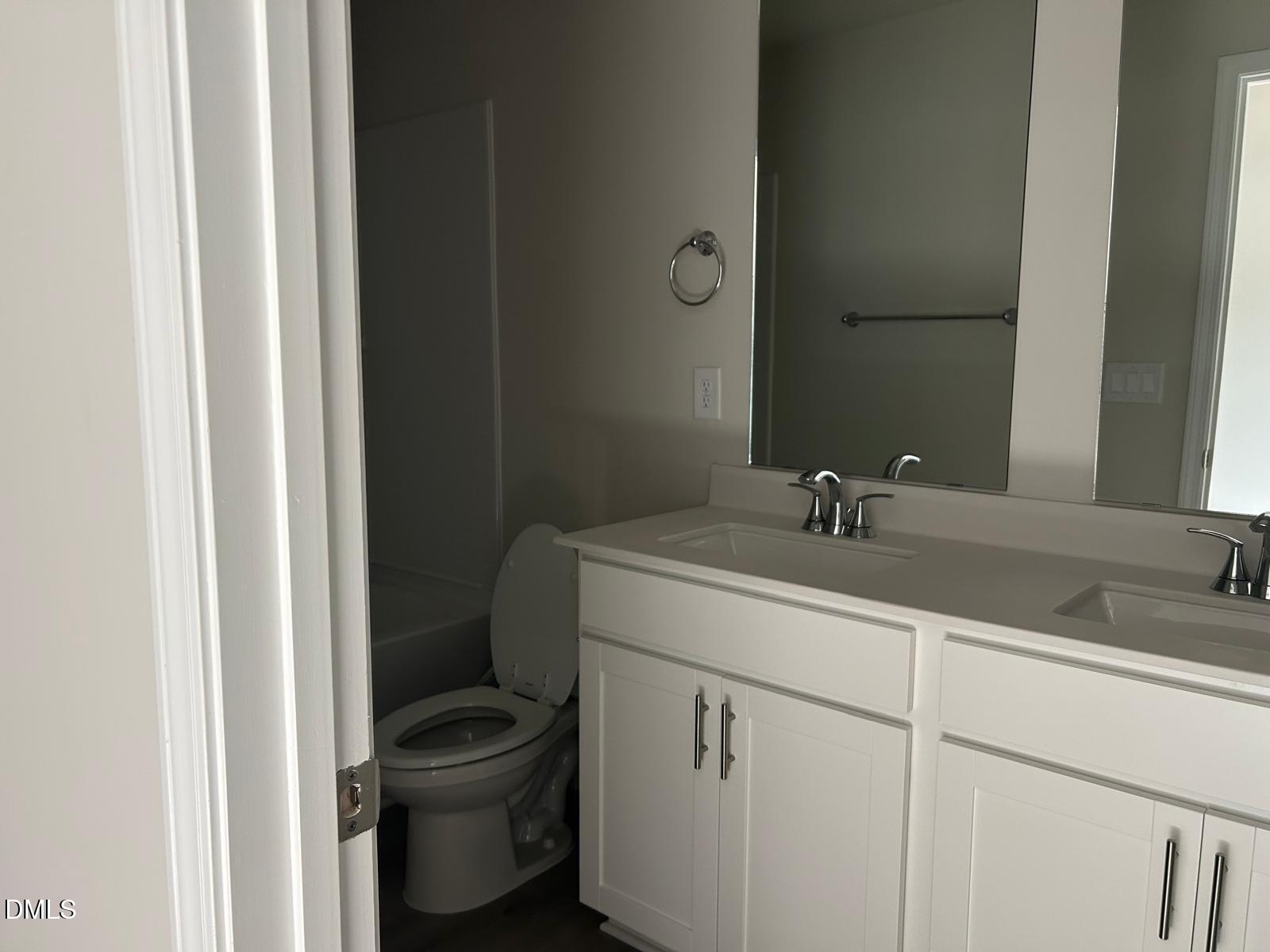 1220 Whitespire Way Zebulon, NC 27597 - Photo 7 of 20 a bathroom with a sink and a toilet