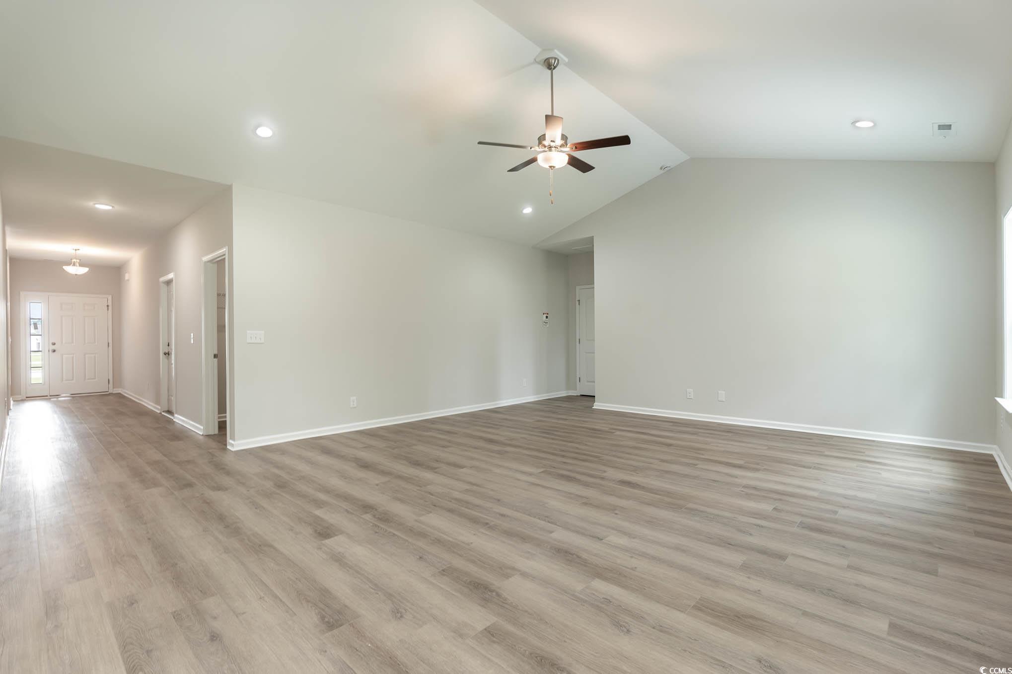 1308 Crooked Hook Road North Myrtle Beach, SC 29582 - Photo 17 of 23 Unfurnished living room with ceiling fan, high vau