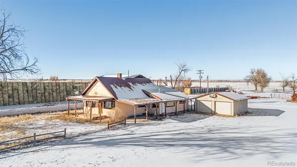 a view of a house with a snow in the background