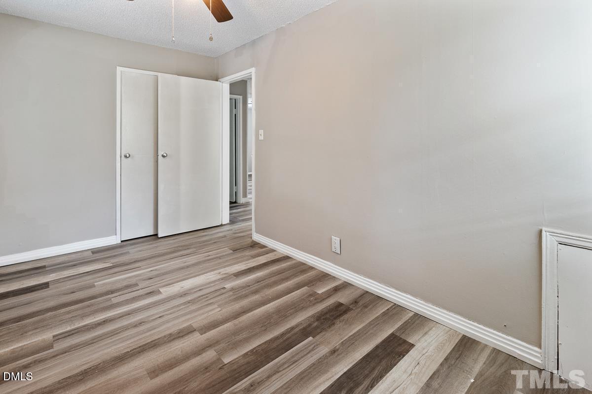 2509 White Oak Avenue Durham, NC 27707 - Photo 11 of 15 a view of a room with wooden floor and white walls