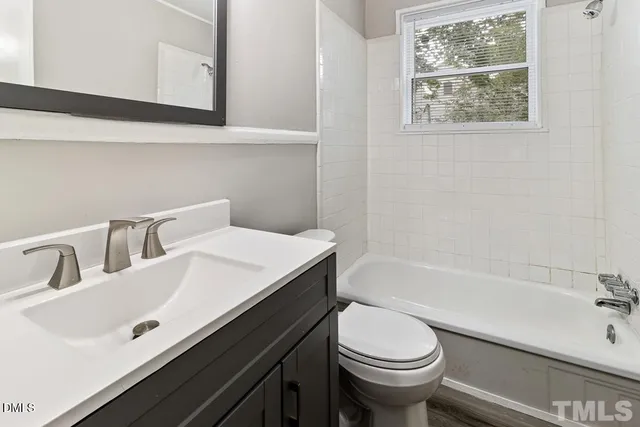 a bathroom with a sink a toilet and bathtub