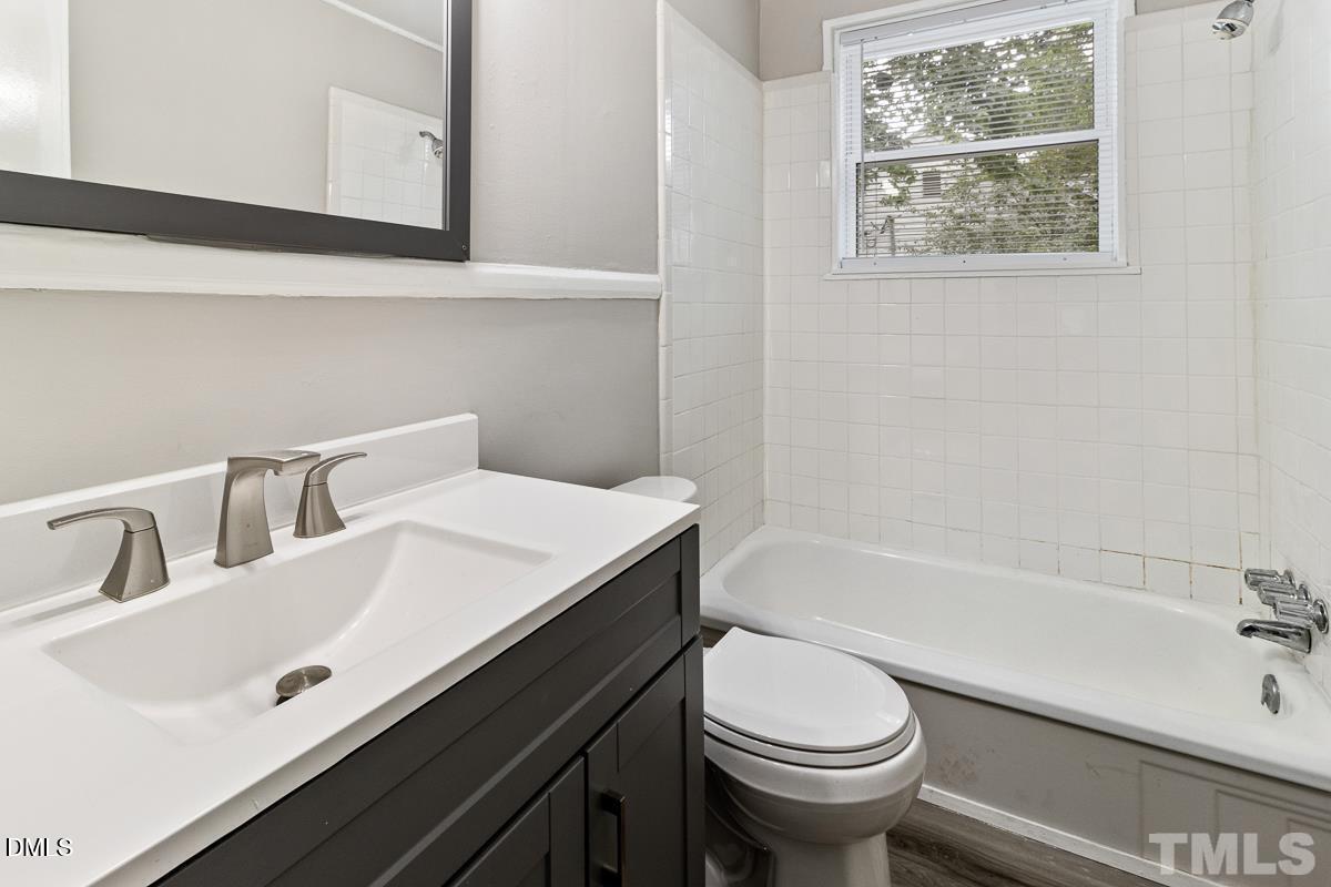 2509 White Oak Avenue Durham, NC 27707 - Photo 12 of 15 a bathroom with a sink a toilet and bathtub