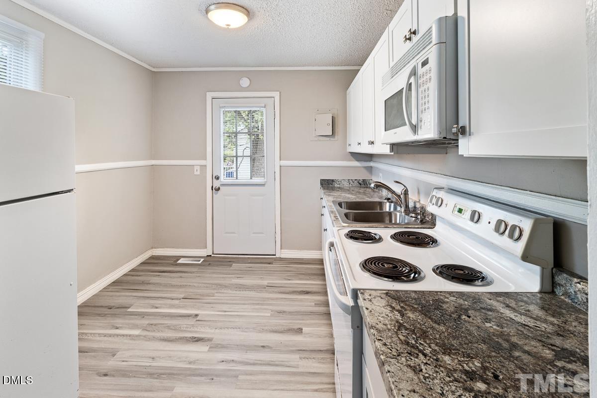 2509 White Oak Avenue Durham, NC 27707 - Photo 6 of 15 a kitchen with a stove and a refrigerator