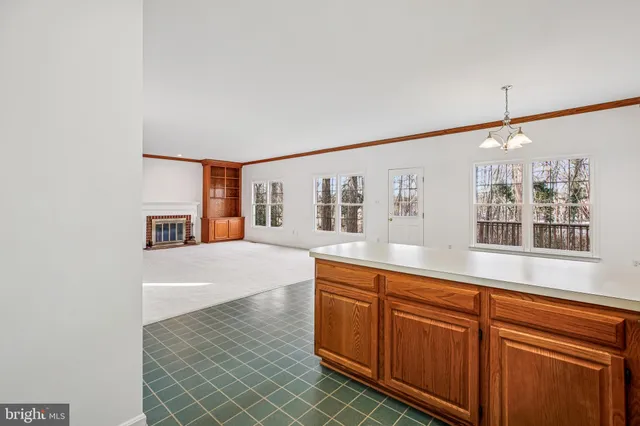 a hall with cabinets and window