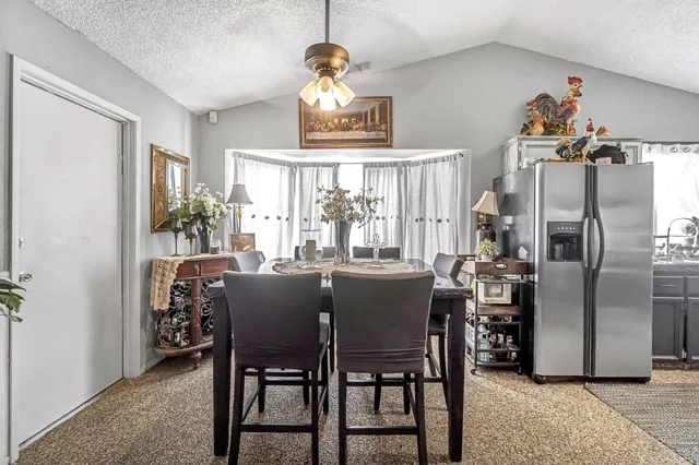 a dining room with furniture a chandelier and window