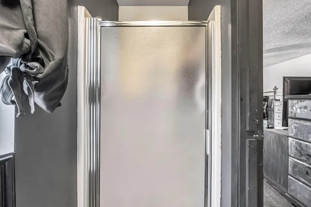 a bathroom with a glass shower door