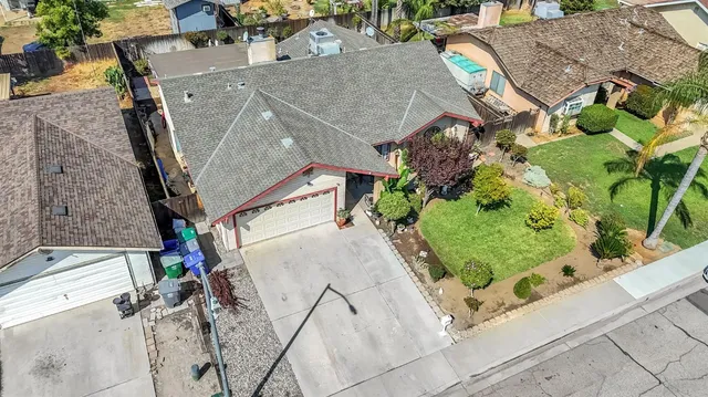 an aerial view of a house with a yard and garden
