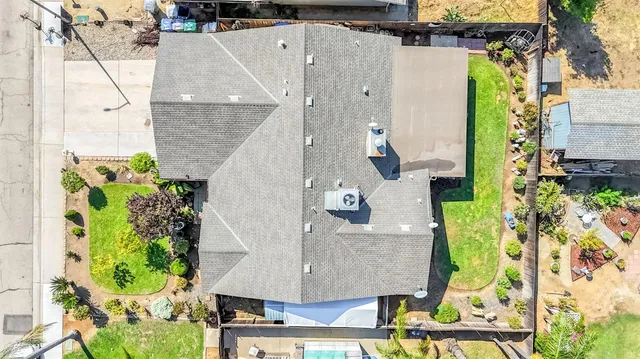 an aerial view of a house with a yard and potted plants