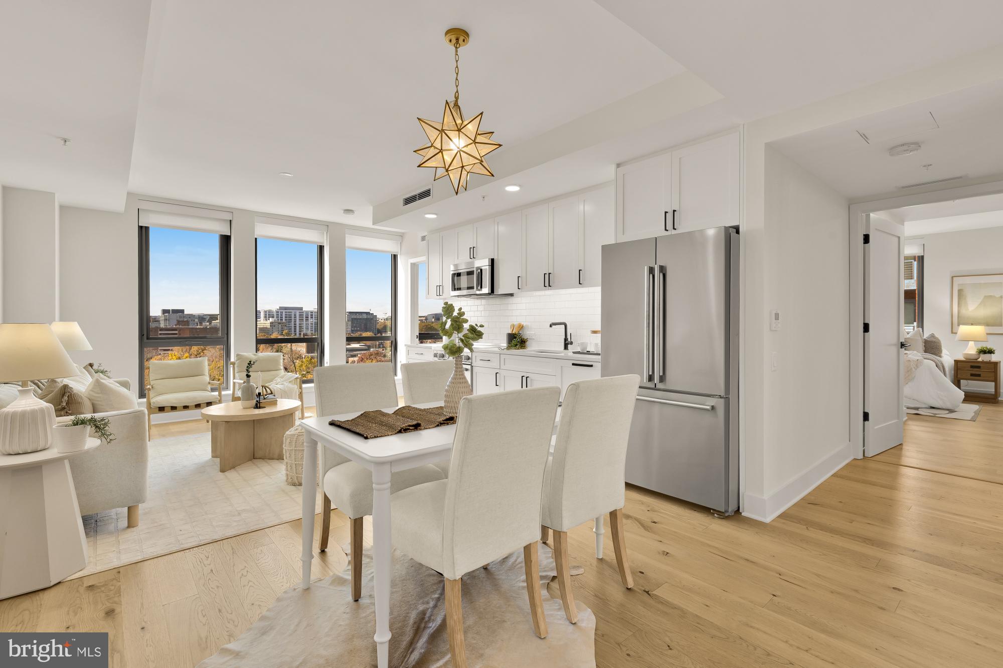 a kitchen with a dining table chairs refrigerator and a fireplace