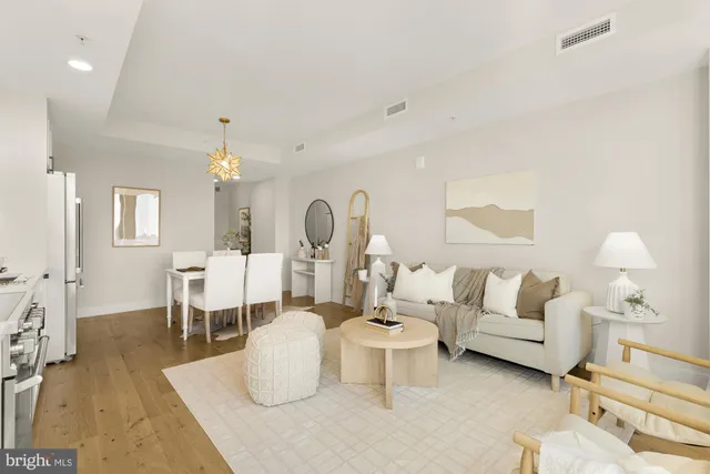 a living room with furniture a lamp and a chandelier