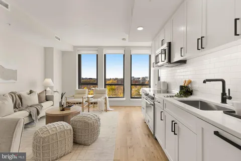 a living room with furniture and large windows