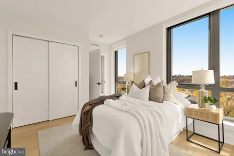 a bedroom with a bed and a large mirror