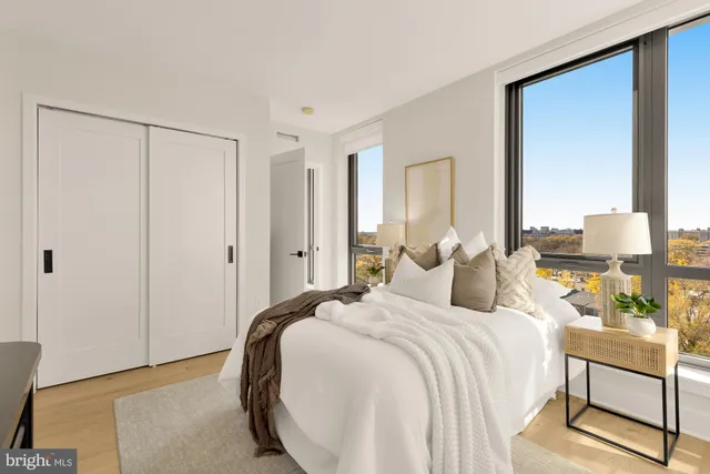 a bedroom with a bed and a large mirror