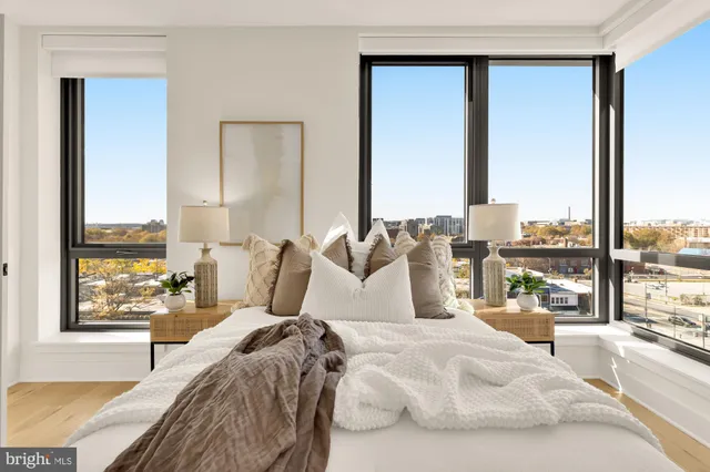 a bedroom with a large bed and a large window